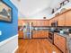 Modern kitchen with stainless steel appliances, granite countertops, and wood floors at 1167 Blue Bird Ln, Wake Forest, NC 27587