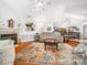 Bright living room with a fireplace, high ceilings, and an open floor plan leading to the kitchen and dining area at 1167 Blue Bird Ln, Wake Forest, NC 27587