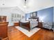 Spacious main bedroom featuring wood floors, a blue accent wall, and ample natural light from a large window at 1167 Blue Bird Ln, Wake Forest, NC 27587