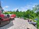 Outdoor patio area featuring comfortable seating, lush landscaping, and a beautiful stone design at 1167 Blue Bird Ln, Wake Forest, NC 27587