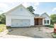 Charming new construction home featuring white siding, brick accents, and an attached two-car garage at 1229 Lawndale Dr, Graham, NC 27253