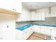 Bright new kitchen featuring white cabinets, blue countertops, and stainless steel appliances at 1229 Lawndale Dr, Graham, NC 27253