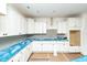 Bright new kitchen featuring white cabinets, blue countertops, and stainless steel appliances at 1229 Lawndale Dr, Graham, NC 27253
