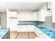 Bright new kitchen featuring white cabinets, blue countertops, and stainless steel appliances at 1229 Lawndale Dr, Graham, NC 27253