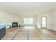 Spacious living room with fireplace, neutral walls, and large windows for natural light at 1229 Lawndale Dr, Graham, NC 27253