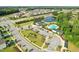 Community aerial with a pool, pond, clubhouse, parking, and green spaces at 125 Alumroot Rd, Holly Springs, NC 27540