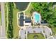 Top-down view of the community clubhouse, pool, parking, and pond at 125 Alumroot Rd, Holly Springs, NC 27540
