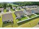 New homes in a well maintained community with green lawns at 125 Alumroot Rd, Holly Springs, NC 27540