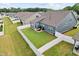 Wide view of fenced backyard with lush grass and home exterior at 125 Alumroot Rd, Holly Springs, NC 27540