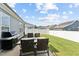 Cozy backyard patio with a grill and outdoor seating for four at 125 Alumroot Rd, Holly Springs, NC 27540