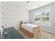Cozy bedroom featuring a large window and a bed with a pullout bed frame at 125 Alumroot Rd, Holly Springs, NC 27540