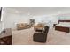 Bonus room view with sofas, desk area and a bedroom separated by half wall at 125 Alumroot Rd, Holly Springs, NC 27540