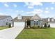 Charming home with a two-car garage, manicured lawn, and inviting curb appeal at 125 Alumroot Rd, Holly Springs, NC 27540