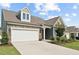 Attractive home with brick and siding, a two-car garage, and well-maintained landscaping at 125 Alumroot Rd, Holly Springs, NC 27540