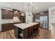 Spacious kitchen featuring a central island, pendant lights, and sleek stainless steel appliances at 125 Alumroot Rd, Holly Springs, NC 27540