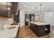 Well-appointed kitchen with quartz countertops, wood flooring, and stainless steel appliances at 125 Alumroot Rd, Holly Springs, NC 27540