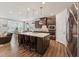 Modern kitchen with a large island, pendant lighting, and stainless steel appliances at 125 Alumroot Rd, Holly Springs, NC 27540