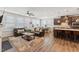 Open-concept living room with hardwood floors, a ceiling fan, and lots of natural light at 125 Alumroot Rd, Holly Springs, NC 27540