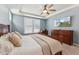 Spacious main bedroom features a ceiling fan, a large bed, and lots of dresser space at 125 Alumroot Rd, Holly Springs, NC 27540