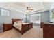 Relaxing main bedroom with a tray ceiling, ceiling fan, and a large window at 125 Alumroot Rd, Holly Springs, NC 27540