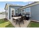 Outdoor patio featuring a dining table, chairs, and a grill, perfect for entertaining at 125 Alumroot Rd, Holly Springs, NC 27540
