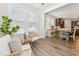 Bright sunroom with rattan seating, large windows, and hardwood flooring at 125 Alumroot Rd, Holly Springs, NC 27540