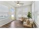 Cozy sunroom features ample natural light, rattan chairs, and a view of the backyard at 125 Alumroot Rd, Holly Springs, NC 27540
