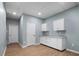 Finished basement area features white cabinets with granite counters and recessed lighting at 145 Mariah Towns Way, Garner, NC 27529