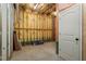 Unfinished basement with yellow insulation, a concrete floor, and a closed, white door at 145 Mariah Towns Way, Garner, NC 27529