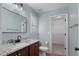 Well-lit bathroom with a granite countertop vanity and a walk-in closet in view at 145 Mariah Towns Way, Garner, NC 27529