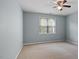 Cozy bedroom with soft carpet, a window for natural light, and a ceiling fan at 145 Mariah Towns Way, Garner, NC 27529