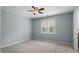 Simple bedroom with soft carpet, a window for natural light, and a ceiling fan at 145 Mariah Towns Way, Garner, NC 27529