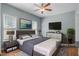 This bedroom features a gray color scheme, laminate wood floors, 2 windows, and a ceiling fan at 145 Mariah Towns Way, Garner, NC 27529