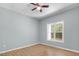 This spacious bedroom has a ceiling fan, wood-look flooring, and a window with a view of the outdoors at 145 Mariah Towns Way, Garner, NC 27529
