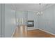 Open living space with hard wood floors, modern lighting, lots of natural light, and a corner fireplace at 145 Mariah Towns Way, Garner, NC 27529
