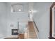 Bright living room featuring hardwood floors, a fireplace, tall ceilings, and stairs to the upper floor at 145 Mariah Towns Way, Garner, NC 27529