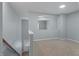The home features a loft area with carpet flooring and an archway overlooking the main level at 145 Mariah Towns Way, Garner, NC 27529