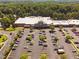 Aerial view of Lowe's surrounded by parking and lush green trees providing shade at 150 Gosford Ln, Garner, NC 27529