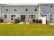 Backyard featuring well maintained lawn, privacy fences, and new townhome construction at 150 Gosford Ln, Garner, NC 27529