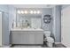 Stylish bathroom featuring double sinks, framed mirror, sleek fixtures and a decorative shelf at 150 Gosford Ln, Garner, NC 27529