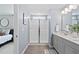 Well-lit bathroom with a glass shower, and double vanity with a large mirror at 150 Gosford Ln, Garner, NC 27529