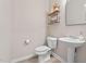 Powder room with pedestal sink, modern fixtures and decor at 150 Gosford Ln, Garner, NC 27529