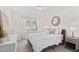 Bright bedroom with a large window, comfortable decor, and a stylish nightstand at 150 Gosford Ln, Garner, NC 27529