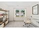 Bright bedroom with neutral walls, carpet, and a modern work desk near the large double windows at 150 Gosford Ln, Garner, NC 27529