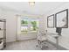Cozy bedroom featuring neutral walls, carpet, and a modern work desk with a view from the large double windows at 150 Gosford Ln, Garner, NC 27529