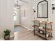 Inviting foyer with hardwood floors, stylish console table, and decorative mirror at 150 Gosford Ln, Garner, NC 27529