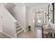 Inviting foyer with staircase, stylish console table, and decorative mirror at 150 Gosford Ln, Garner, NC 27529