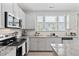 Bright kitchen features granite countertops, subway tile backsplash and stainless steel appliances at 150 Gosford Ln, Garner, NC 27529