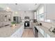Open kitchen boasts gray cabinets, granite countertops and stainless steel appliances at 150 Gosford Ln, Garner, NC 27529
