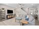 Cozy living room features a ceiling fan, TV and plush sectional sofa at 150 Gosford Ln, Garner, NC 27529